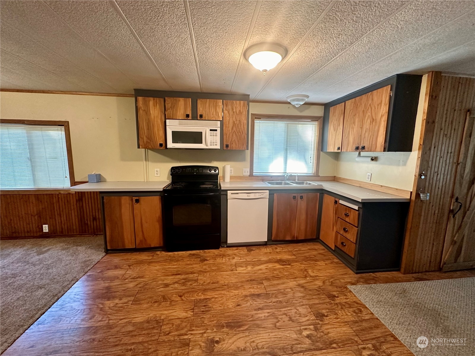 230 Salmon Drive Forks, WA 98331 - Photo 5 of 35 a kitchen with a stove sink and a microwave