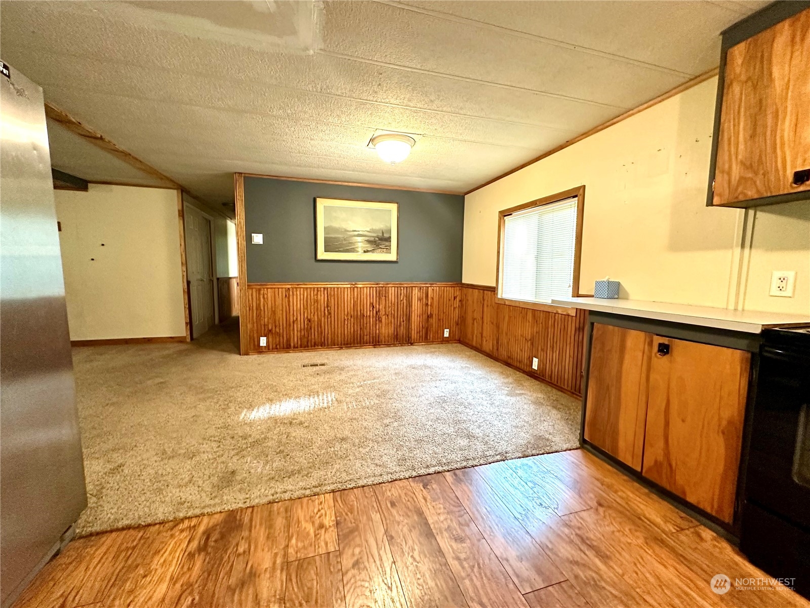 230 Salmon Drive Forks, WA 98331 - Photo 8 of 35 a view of an empty room with wooden floor and a window