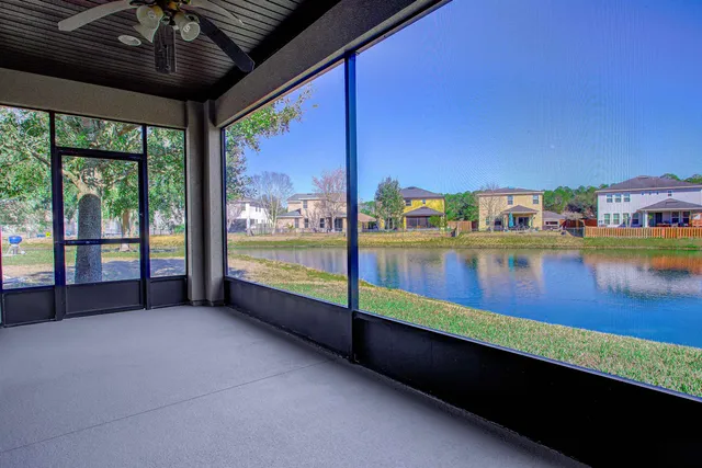 an aerial view of a swimming pool with outdoor seating and yard