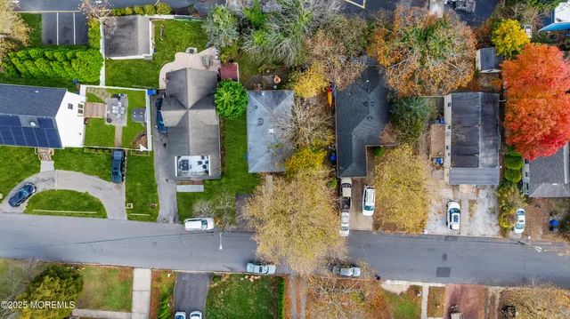 an aerial view of a house with a yard and basket ball court