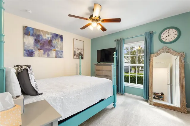 a bedroom with a bed and a painting on the wall