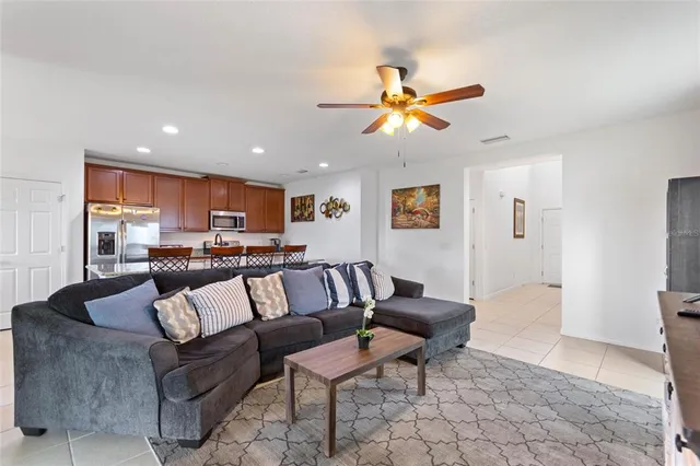a living room with furniture and kitchen view