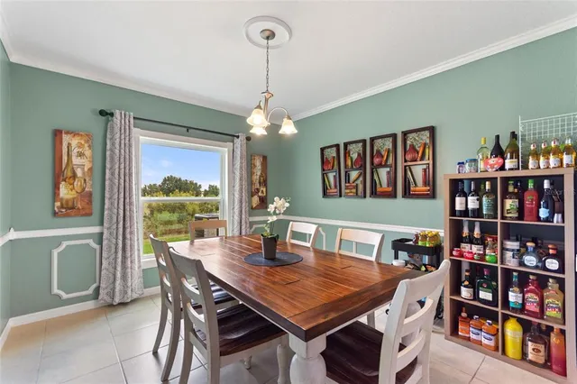 a view of a dining room with furniture a rug and a book shelf
