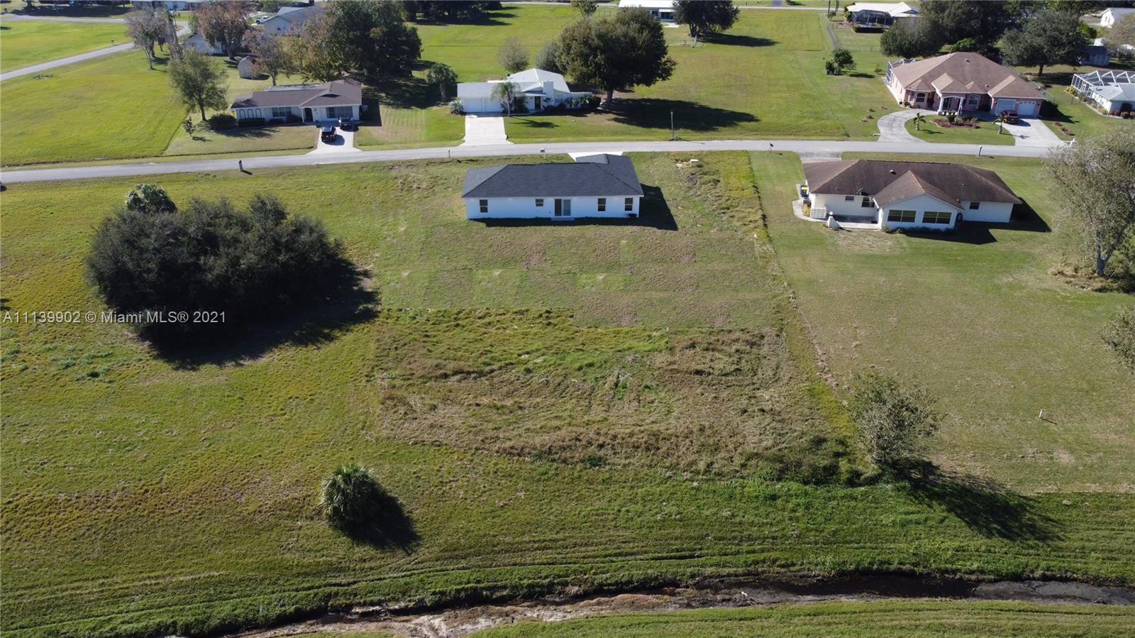 417 Cherry Tree Drive Sebring, FL 33876 - Photo 12 of 39 a view of swimming pool with lawn chairs and a table