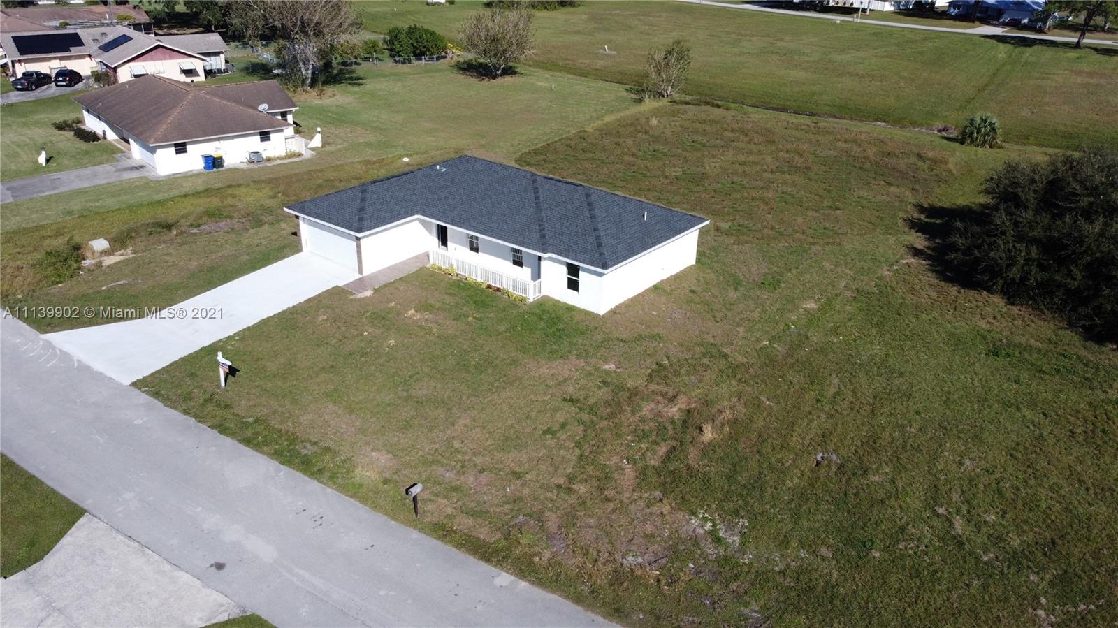 417 Cherry Tree Drive Sebring, FL 33876 - Photo 15 of 39 a view of a swimming pool with a yard