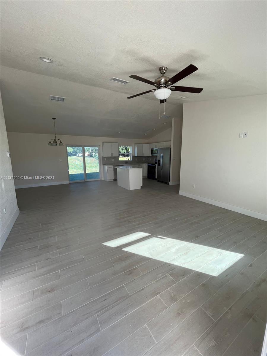 417 Cherry Tree Drive Sebring, FL 33876 - Photo 21 of 39 a view of a livingroom with a ceiling fan and window