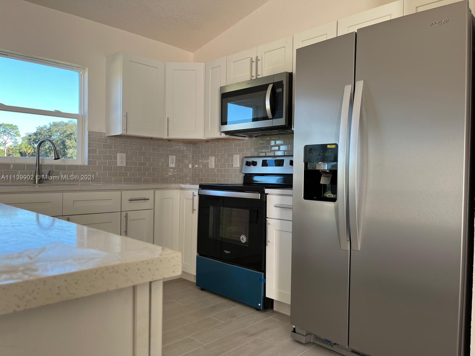417 Cherry Tree Drive Sebring, FL 33876 - Photo 24 of 39 a kitchen with stainless steel appliances granite countertop a refrigerator a stove top oven a sink and dishwasher