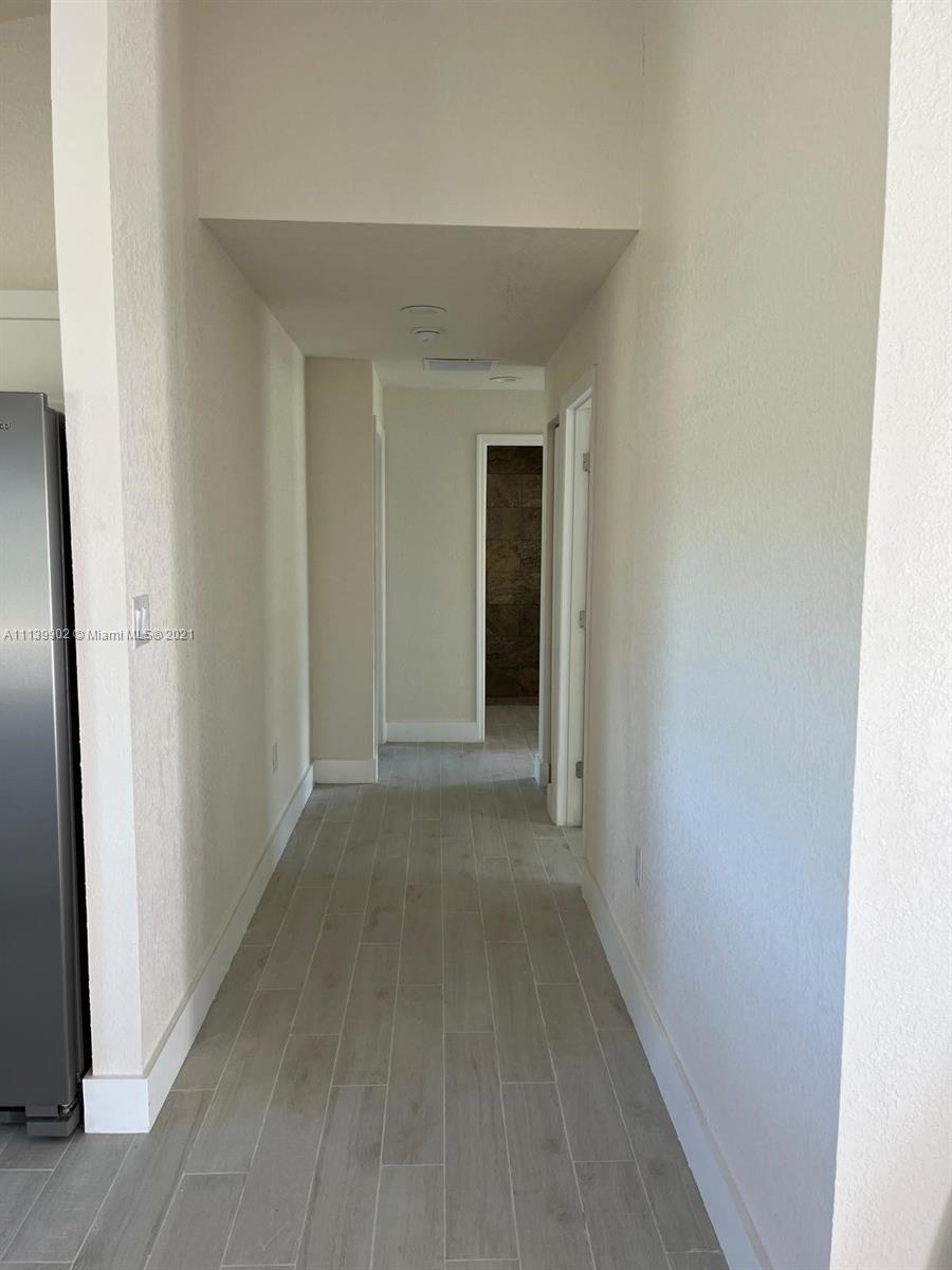 417 Cherry Tree Drive Sebring, FL 33876 - Photo 26 of 39 a view of a hallway with wooden floor