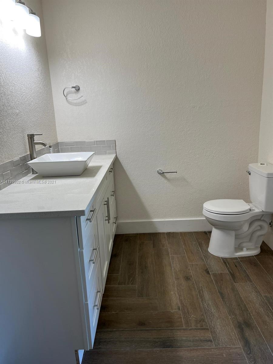 417 Cherry Tree Drive Sebring, FL 33876 - Photo 30 of 39 a bathroom with a sink and a toilet