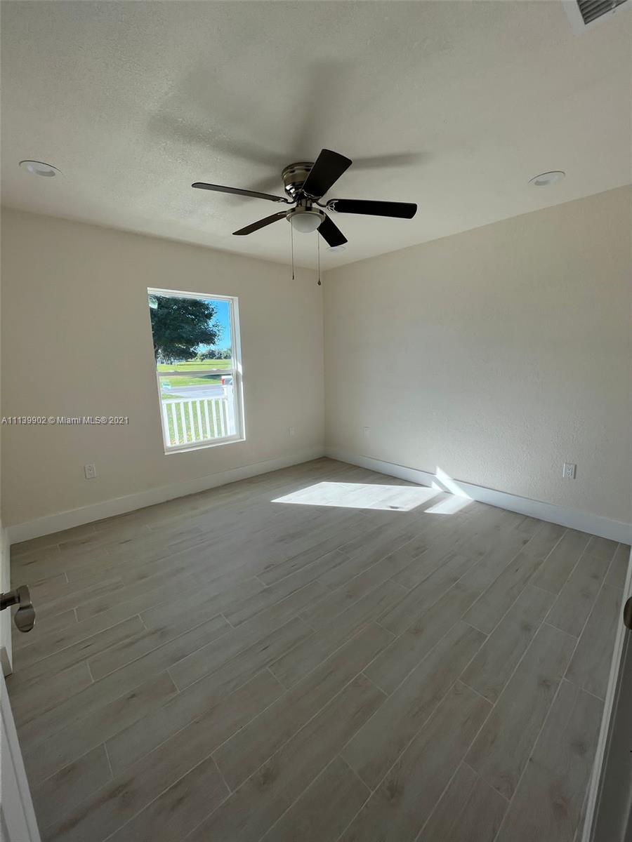 417 Cherry Tree Drive Sebring, FL 33876 - Photo 33 of 39 an empty room with windows