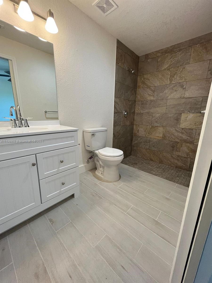 417 Cherry Tree Drive Sebring, FL 33876 - Photo 36 of 39 a bathroom with a toilet a sink and shower