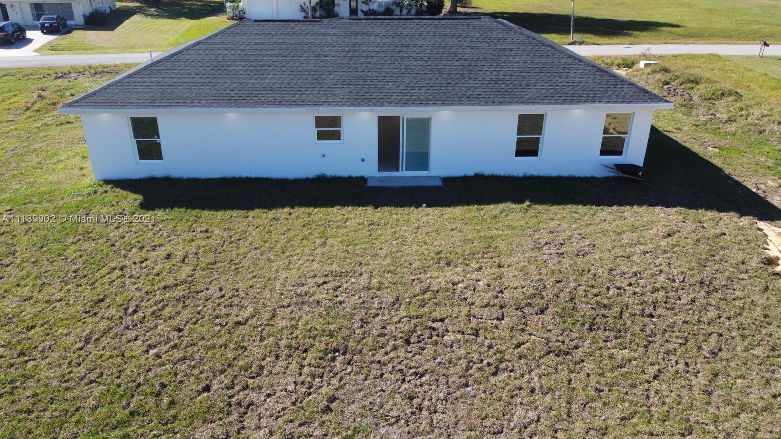 417 Cherry Tree Drive Sebring, FL 33876 - Photo 38 of 39 a house with trees in front of it