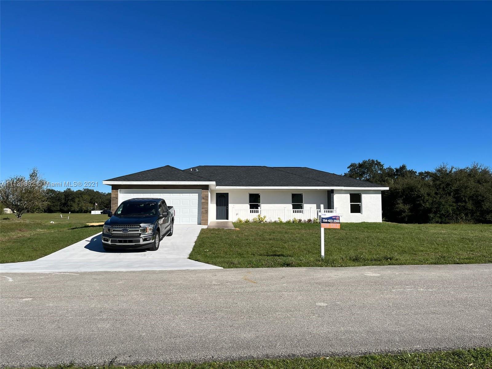 417 Cherry Tree Drive Sebring, FL 33876 - Photo 5 of 39 front view of a house with a yard