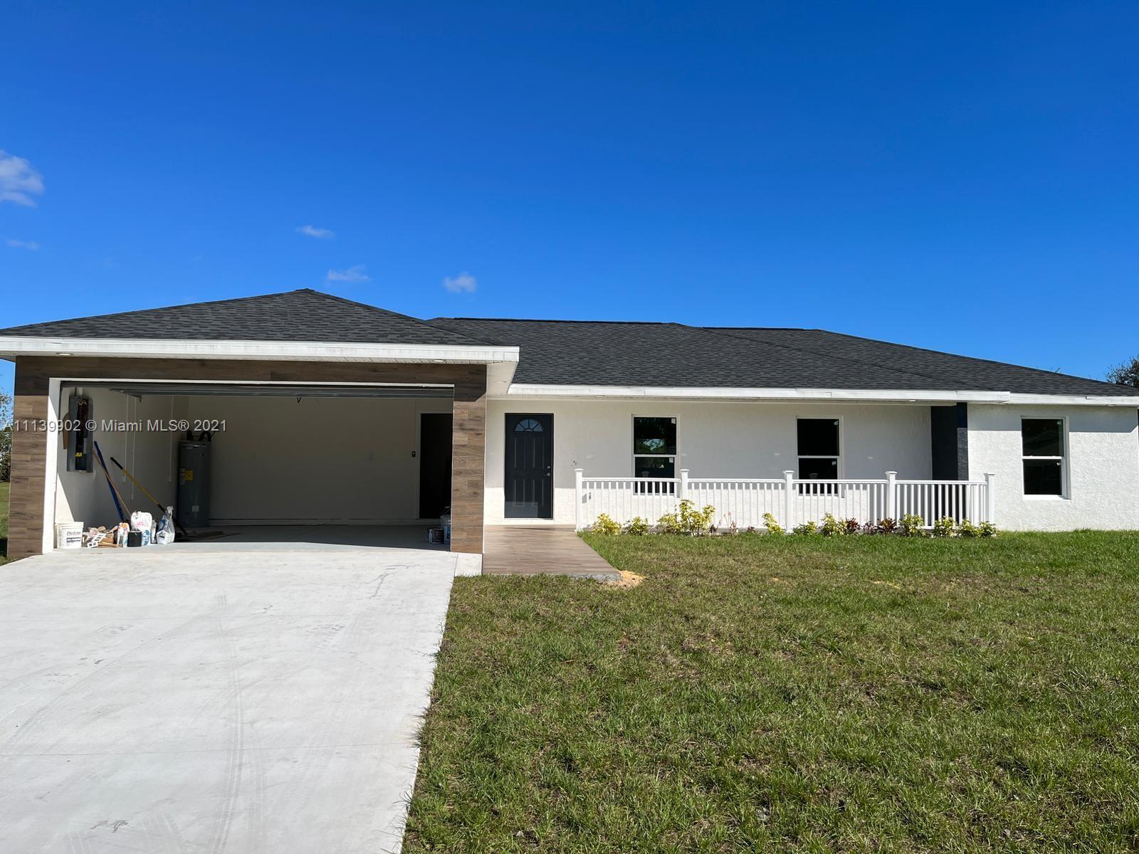 417 Cherry Tree Drive Sebring, FL 33876 - Photo 6 of 39 a front view of a house with yard