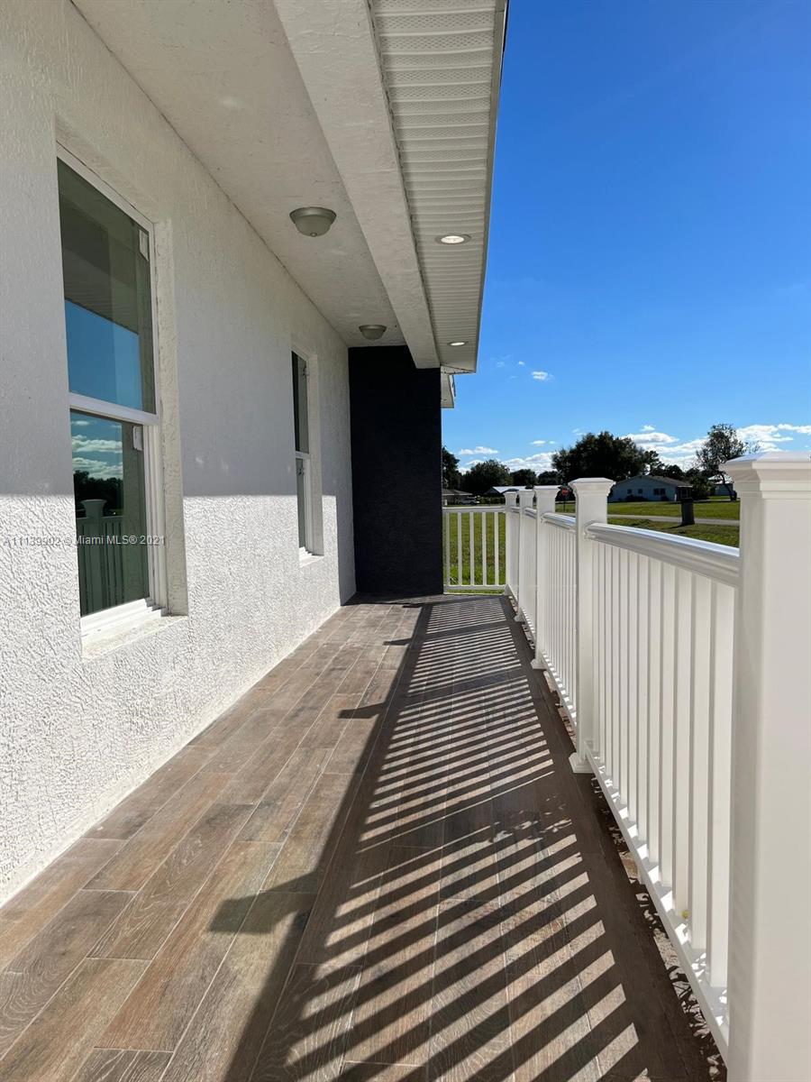 417 Cherry Tree Drive Sebring, FL 33876 - Photo 8 of 39 a view of a balcony with wooden floor