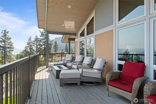 a balcony with furniture and wooden floor