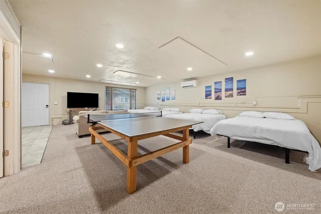 a living room with furniture pool and a flat screen tv
