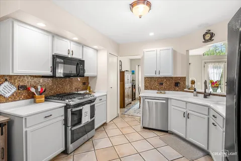 a kitchen with a stove top oven sink and cabinets
