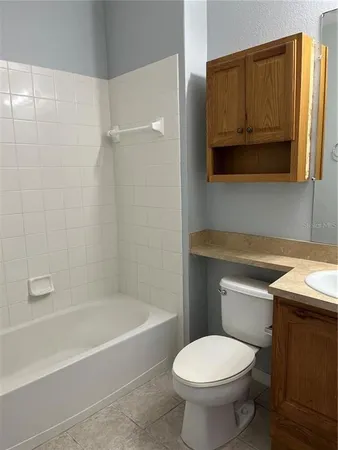 a bathroom with a sink a toilet and bathtub
