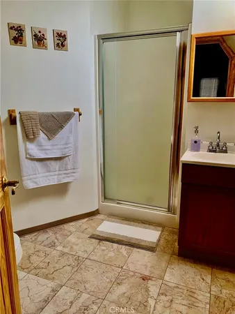 a bedroom with a bed and a mirror