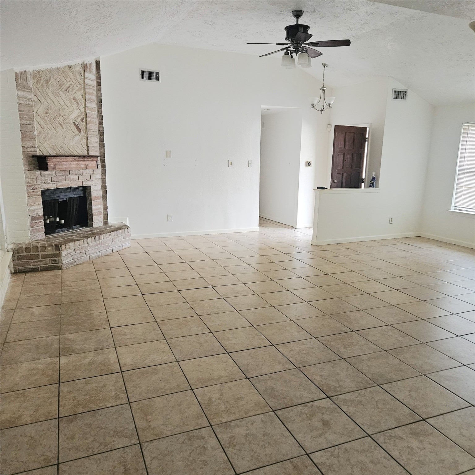 3315 Hombly Road Houston, TX 77066 - Photo 6 of 20 an empty room with windows and fireplace