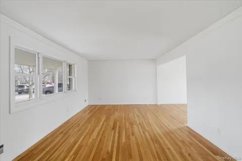 a view of a room with wooden floor and white walls