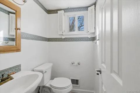 a white toilet sitting next to a bathroom sink