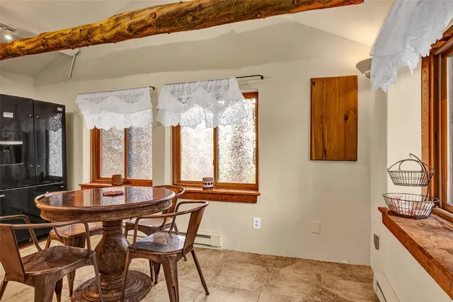 a view of a patio with a table and chairs next to a yard