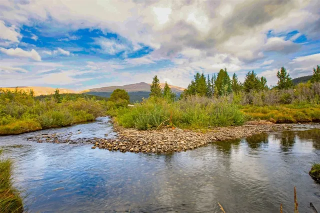 a view of a dining room with furniture and a chandelier