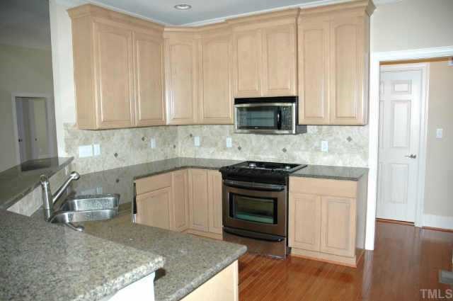 613 Competition Raleigh, NC 27603 - Photo 3 of 10 a kitchen with granite countertop a sink stove and microwave