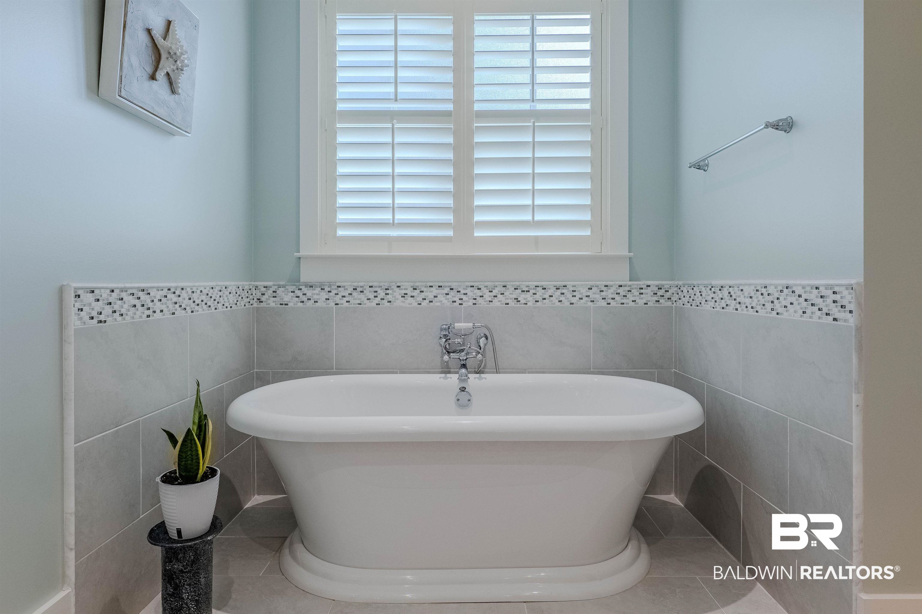 708 Manning Place Fairhope, AL 36532 - Photo 27 of 58 Bathroom with tile walls, a bathtub, and tile patterned floors