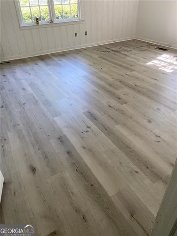 an empty room with wooden floor