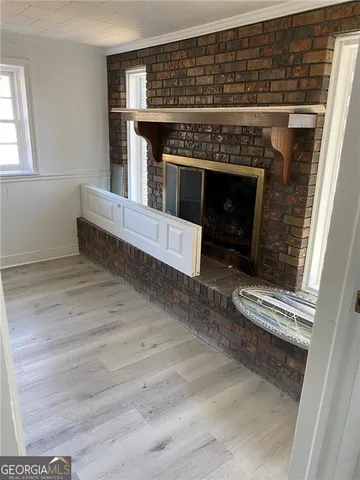 a view of fireplace and wooden floor