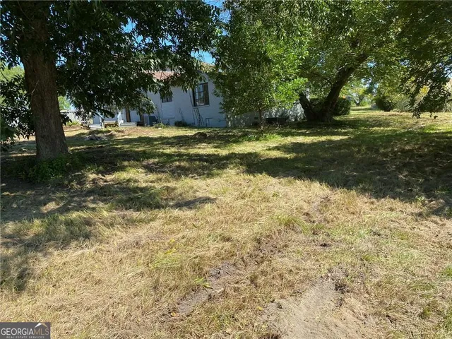 a view of outdoor space with trees all around