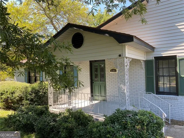 a glass building with trees in front of it