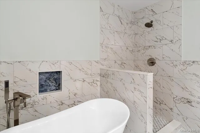 a bathroom with a bathtub and shower