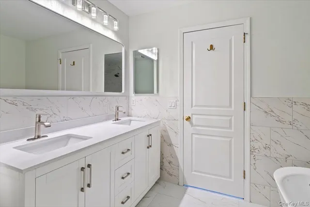a bathroom with a double vanity sink and mirror