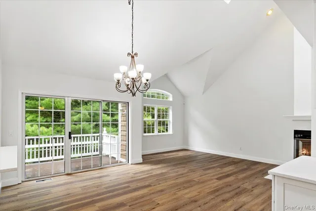 a view of a livingroom with wooden floor and a chandelier