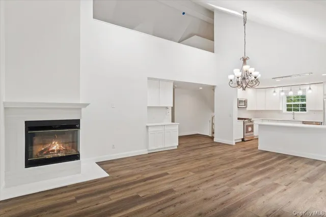 a view of a room with kitchen and fireplace