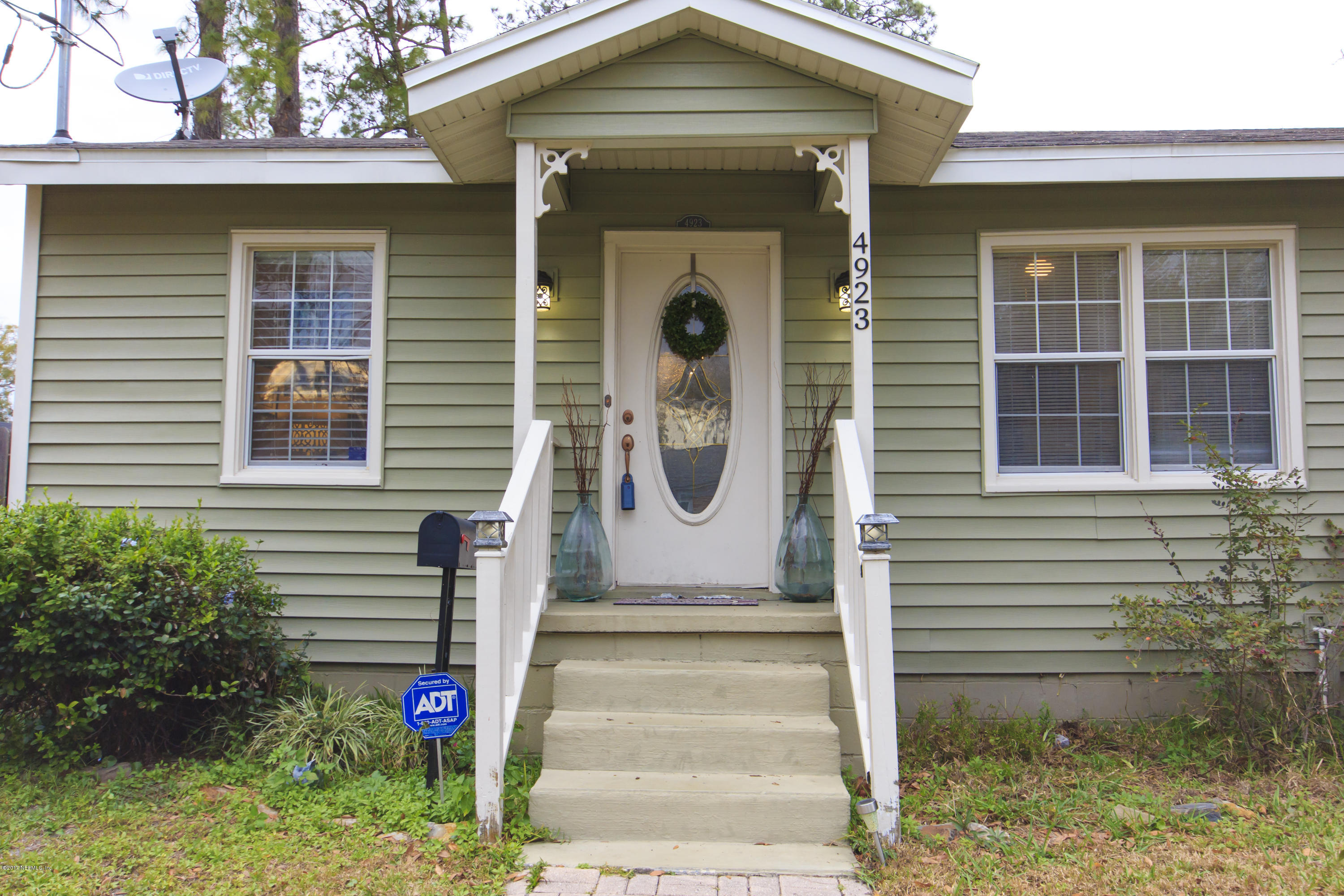 4923 Dundee Road Jacksonville, FL 32210 - Photo 1 of 14 a front view of a house with entryway