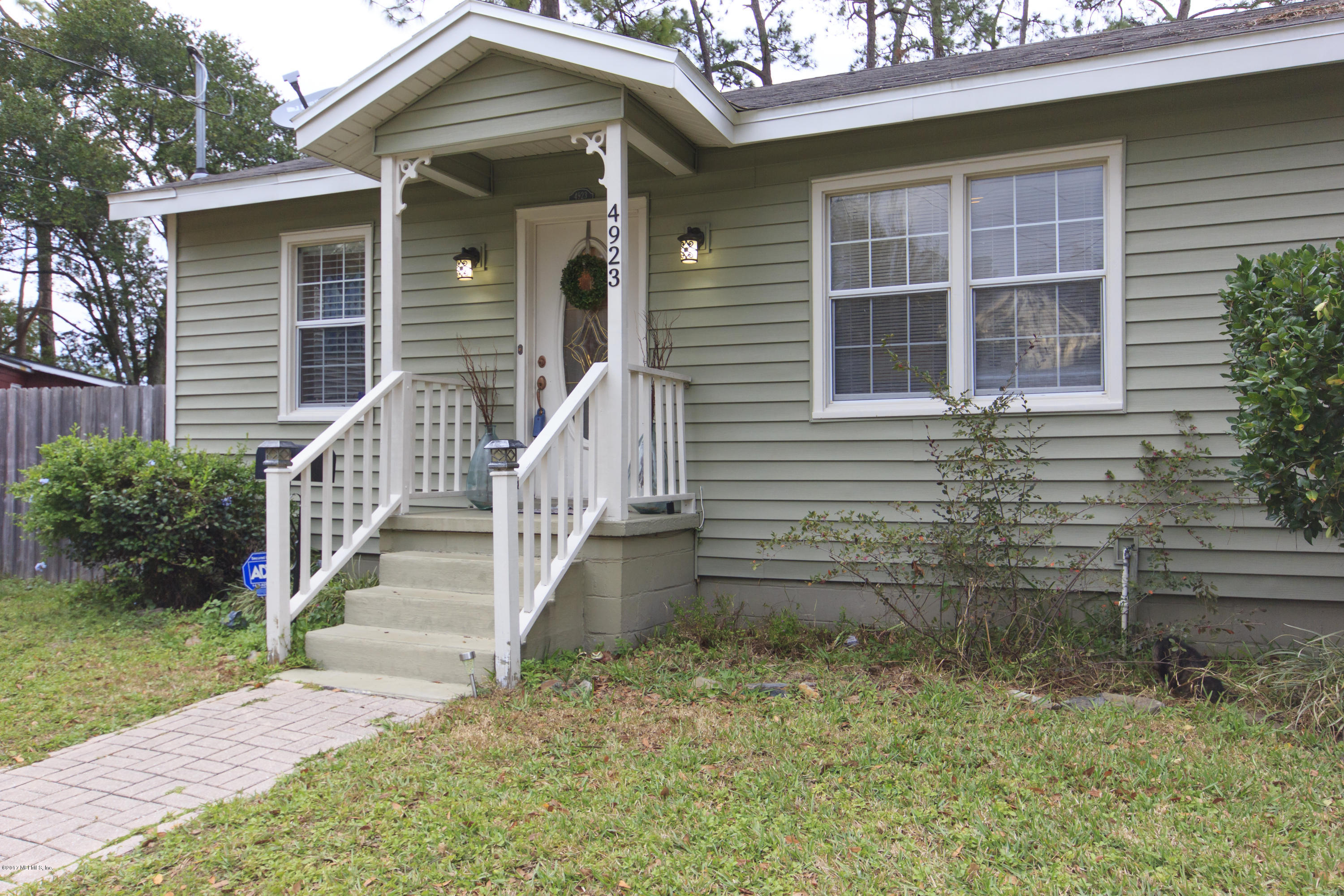 4923 Dundee Road Jacksonville, FL 32210 - Photo 3 of 14 a front view of a house with a yard