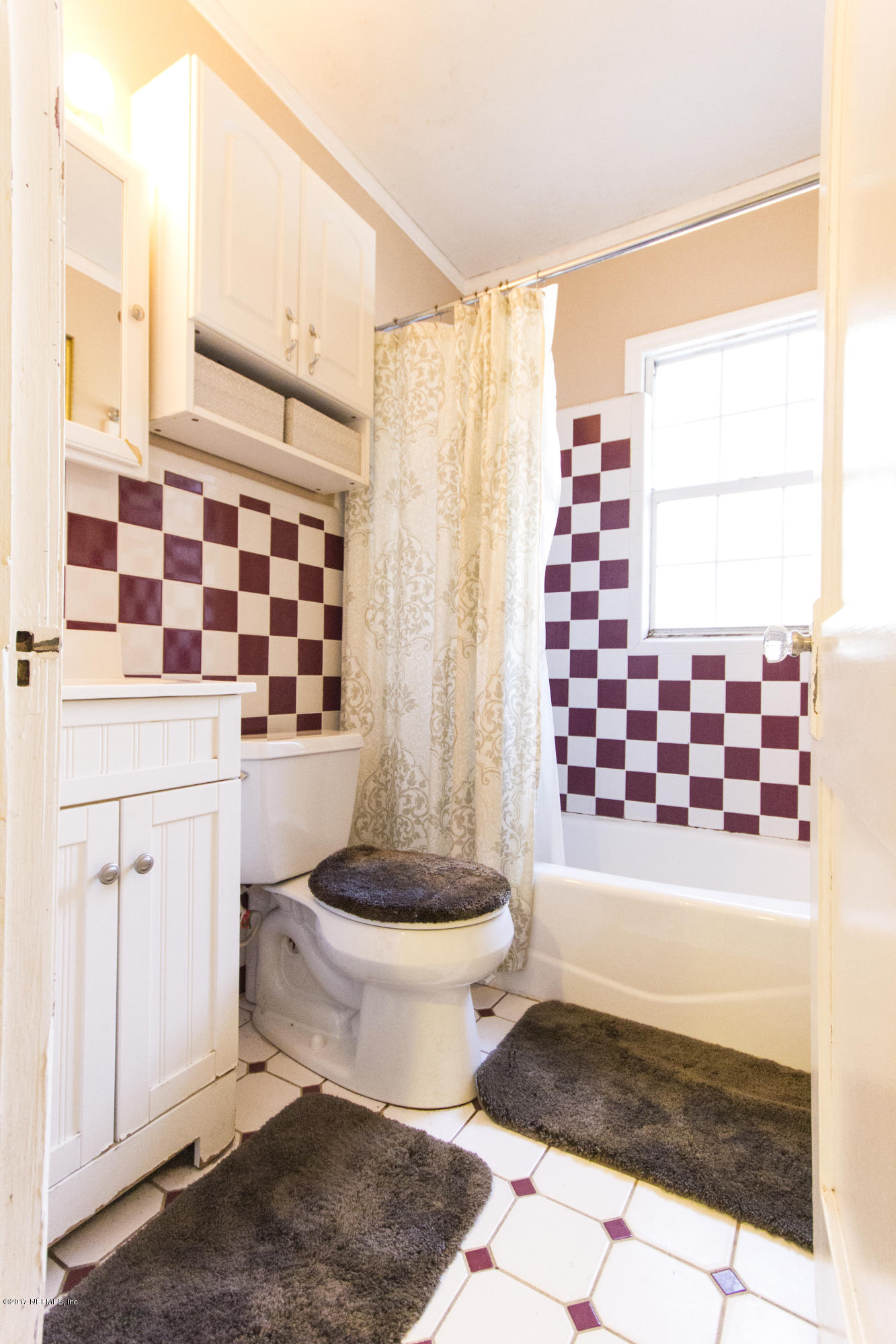 4923 Dundee Road Jacksonville, FL 32210 - Photo 7 of 14 a bathroom with a sink toilet and shower