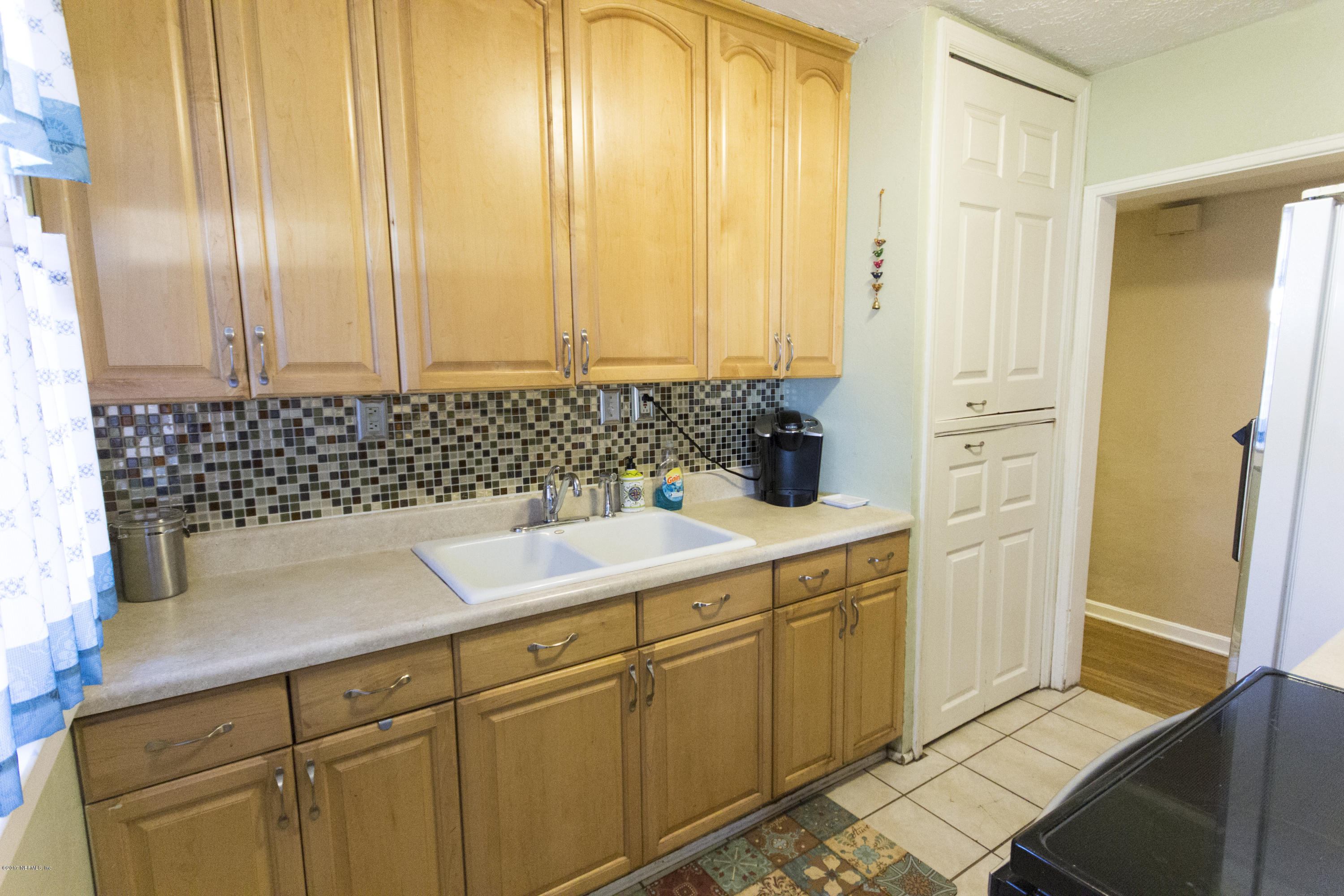 4923 Dundee Road Jacksonville, FL 32210 - Photo 8 of 14 a bathroom with a sink and a mirror
