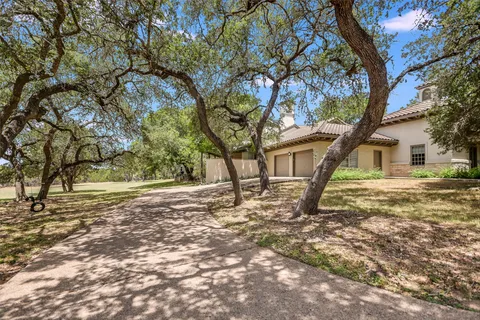 a view of a house with a yard and tree s