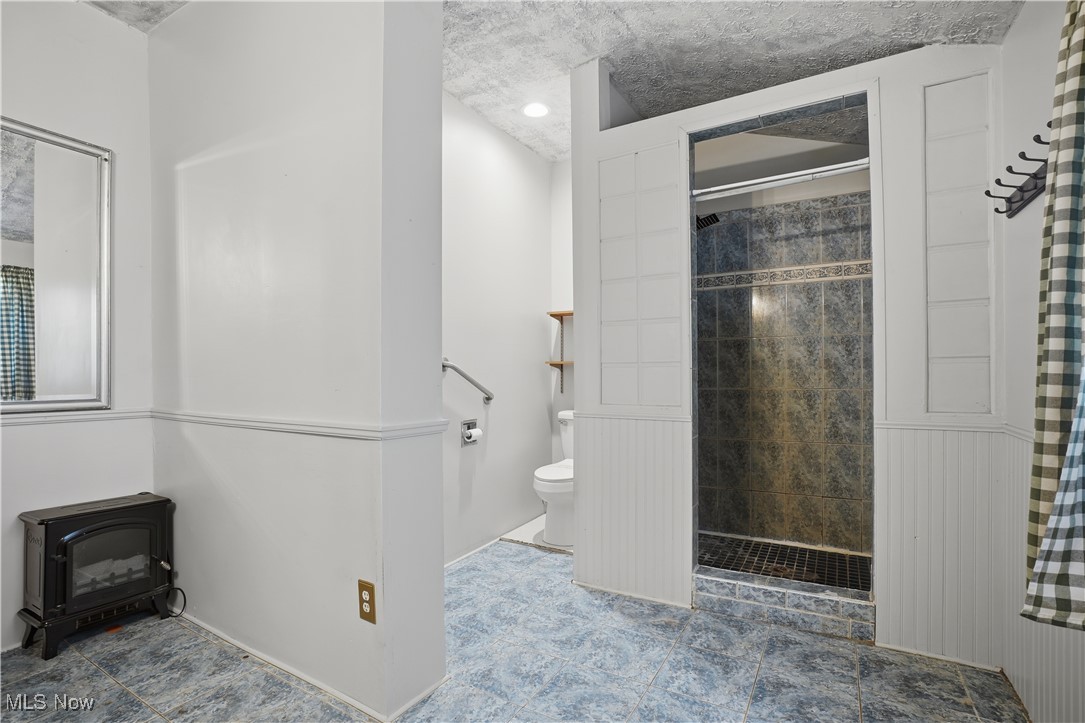 884 Brownville Road Rome, OH 44085 - Photo 23 of 36 Bathroom with a stall shower and a textured ceiling
