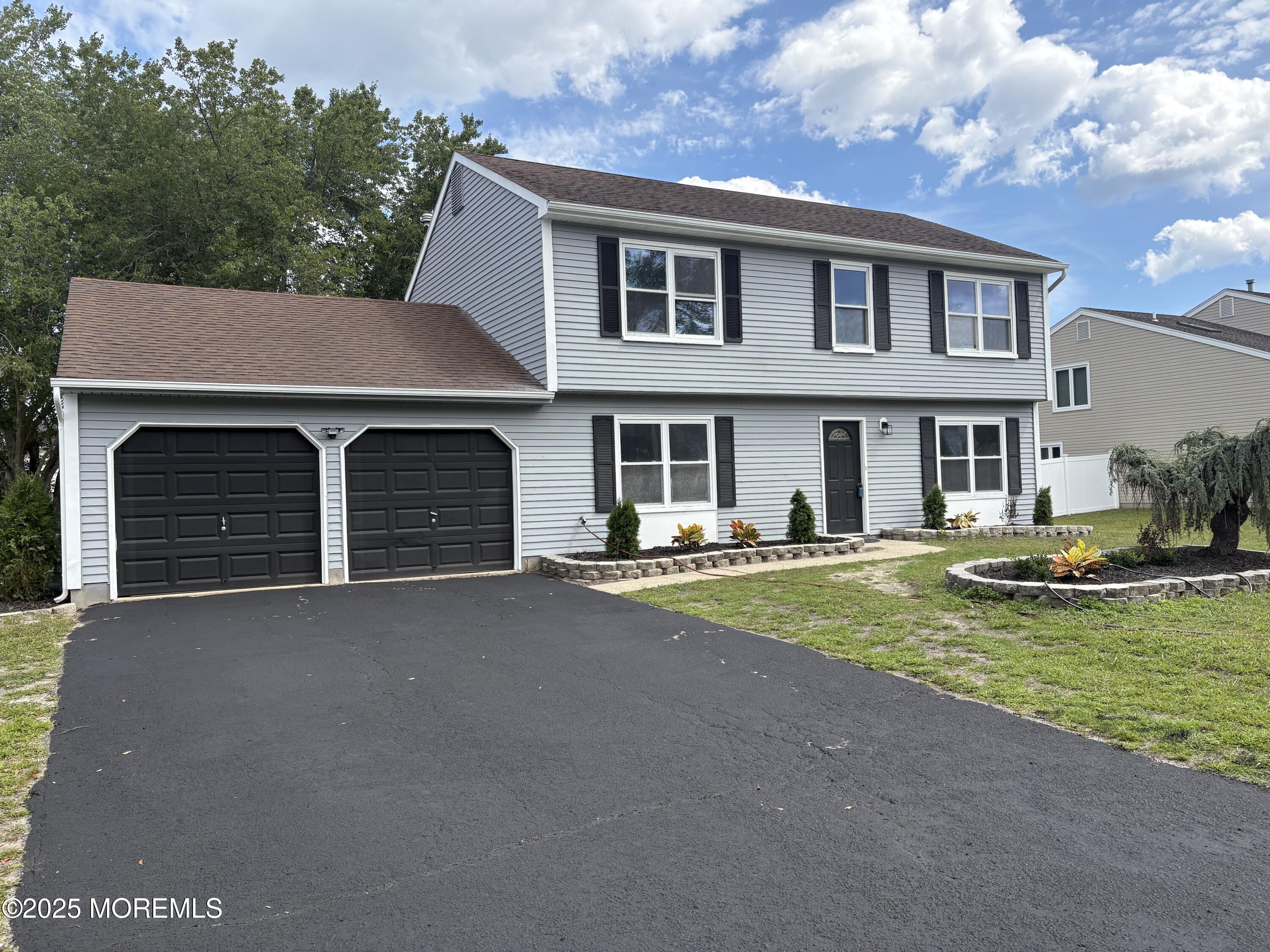 a front view of a house with yard and garage