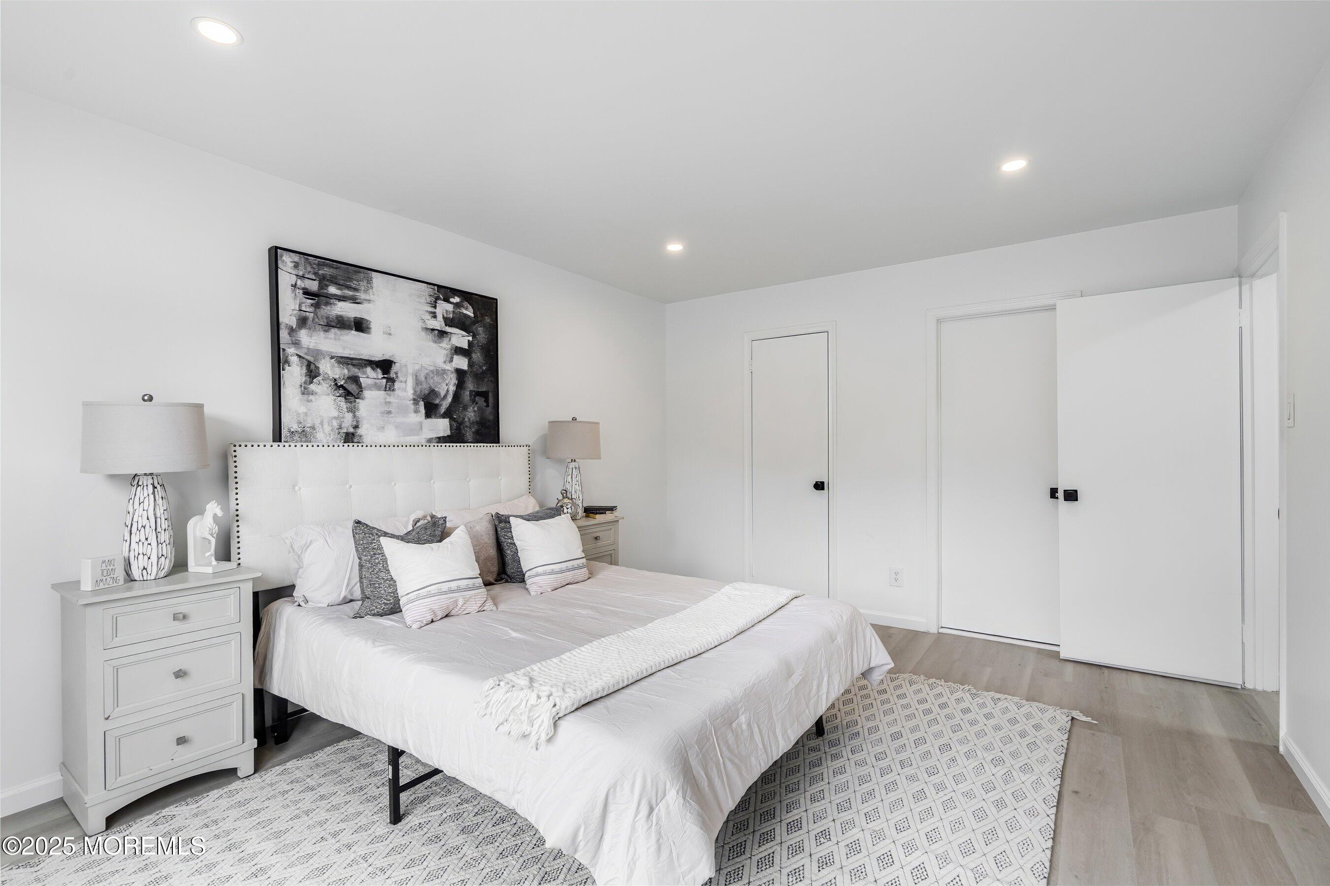 944 Yellowbank Road Toms River, NJ 08753 - Photo 16 of 33 a spacious bedroom with a bed and a lamp on a dresser