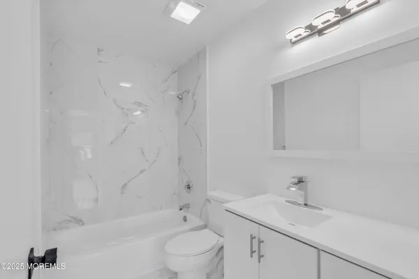 a bathroom with a sink toilet and vanity