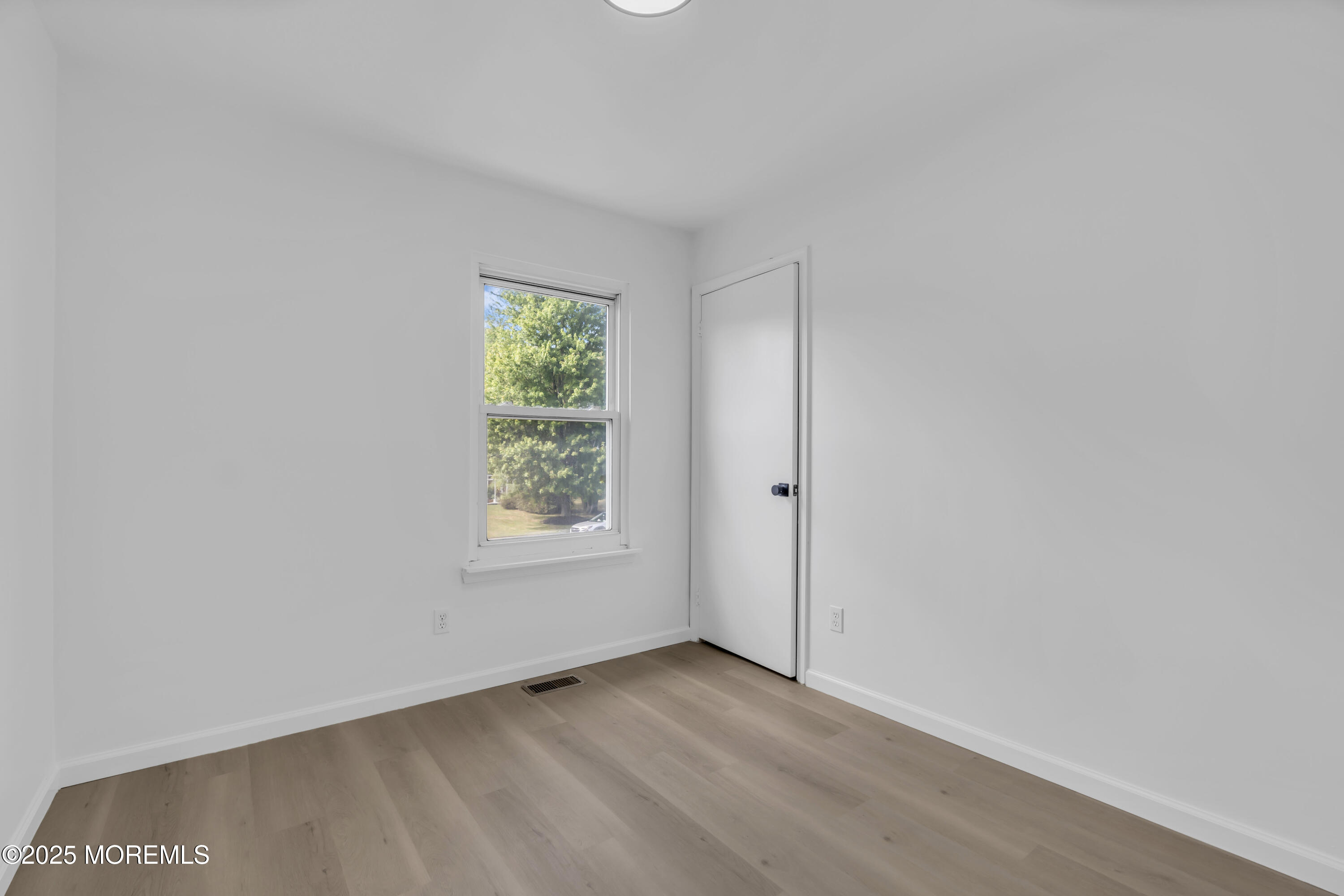 944 Yellowbank Road Toms River, NJ 08753 - Photo 23 of 33 an empty room with wooden floor and windows