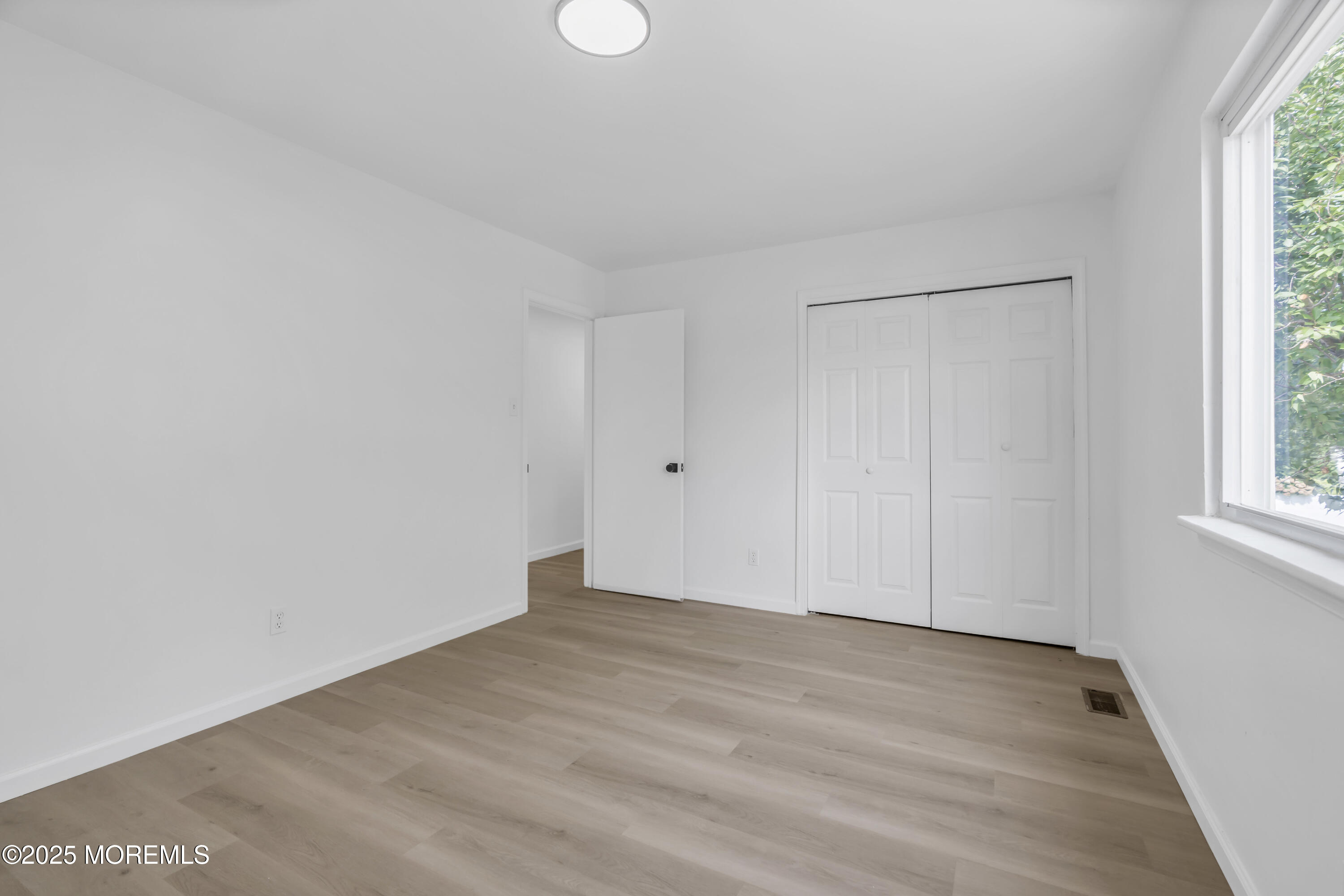 944 Yellowbank Road Toms River, NJ 08753 - Photo 26 of 33 a view of an empty room with wooden floor and a window
